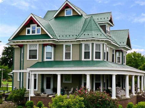 white houses with green metal roofs|green roof with grey siding.